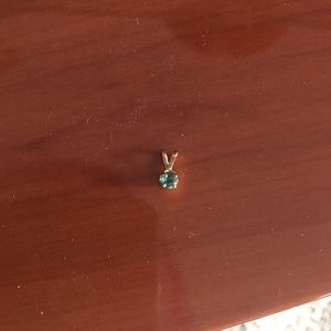 Small gold pendant with emerald